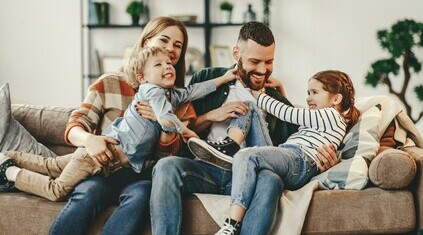 Happy family laughing together in a Bedrock home. 