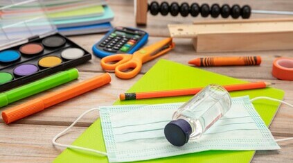 Children's school supplies with medical mask and hand sanitizer (stock image).